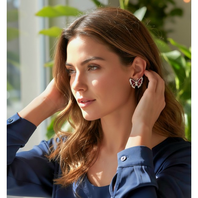 Real Beauty natural 11.9 carat mystery setting Ruby Butterflies .925 Sterling Silver handcrafted earrings - Woman wearing butterfly-shaped ruby earrings, side profile view.