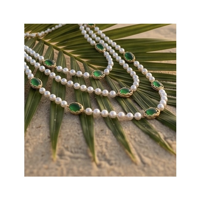 Incredible 48 inches long Freshwater Pearl 10K Gold over .925 Sterling Silver handmade Necklace - Necklace on palm leaf showcasing pearls and green stones in gold settings.