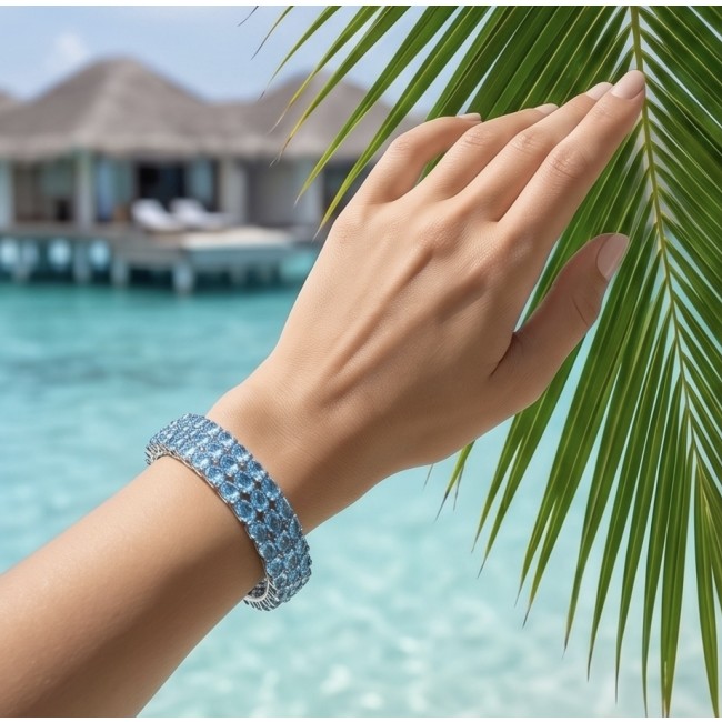 Serenity - Spectacular authentic 145.5 carat Swiss Blue Topaz .925 Sterling Silver handmade bangle Bracelet - Worn on hand, Swiss Blue Topaz bracelet by beach and palm leaves.