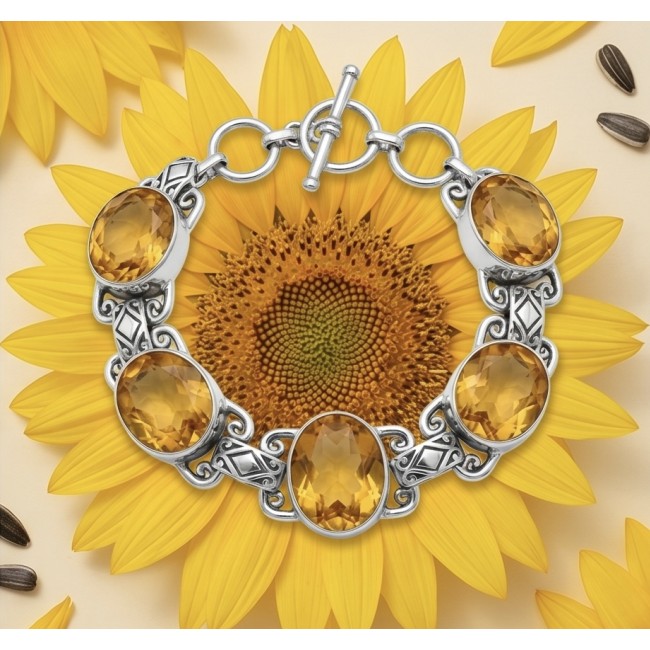 Spectacular oval cut 65.5 carat Lemon Quartz .925 Sterling Silver handcrafted bracelet - Lemon quartz bracelet on sunflower, top view, showcasing oval stones.