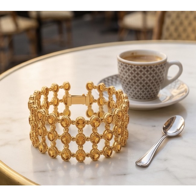 Enchanted Beauty 39.5 carat authentic Brazilian Citrine 18K Gold over .925 Sterling Silver handcrafted Bracelet - Gold bracelet on a marble table with coffee and spoon, top view