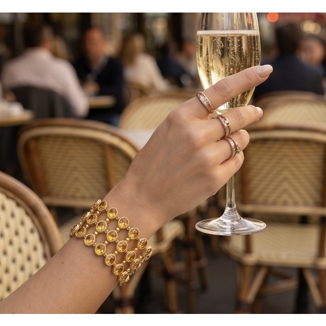 Enchanted Beauty 39.5 carat authentic Brazilian Citrine 18K Gold over .925 Sterling Silver handcrafted Bracelet - Citrine bracelet on wrist holding champagne glass at a café.