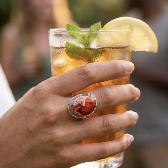 Queen of Fire best quality 22.4 carat Mexican Opal RHODIUM over .925 Sterling Silver handmade ring 5 - Mexican Opal ring worn on hand, side view with iced drink.