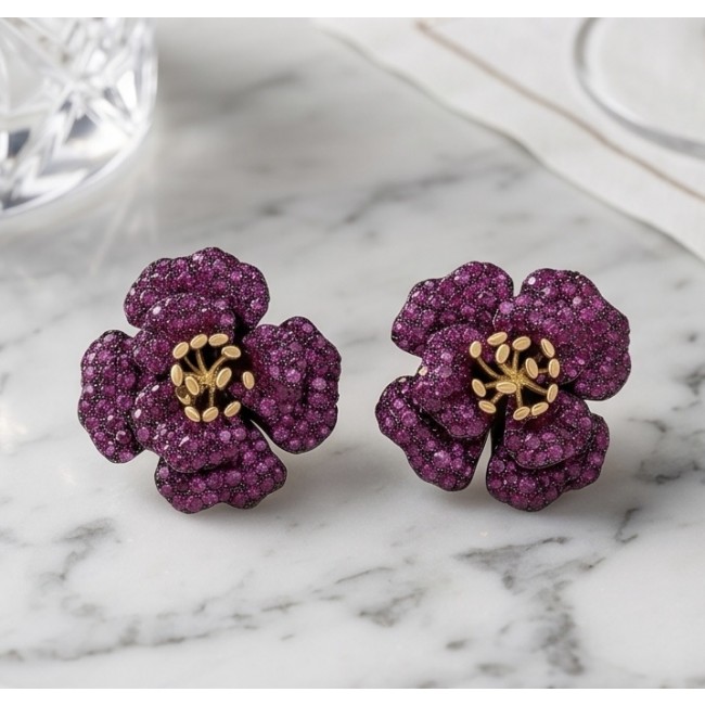 Exotic Flowers - 18.8 carat Mozambique Ruby .925 Sterling Silver dipped in black rhodium 22K Gold handmade Statement Earrings - Close-up of floral ruby earrings on marble surface.