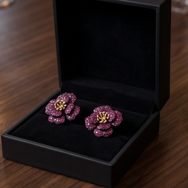 Exotic Flowers - 18.8 carat Mozambique Ruby .925 Sterling Silver dipped in black rhodium 22K Gold handmade Statement Earrings - Pair of ruby flower earrings in open box, top view.