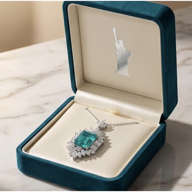 Freedom- Natural 18.5 carat Emerald Moissanite .925 Sterling Silver handcrafted Necklace - Emerald necklace in box, top view, with Statue of Liberty logo inside lid.
