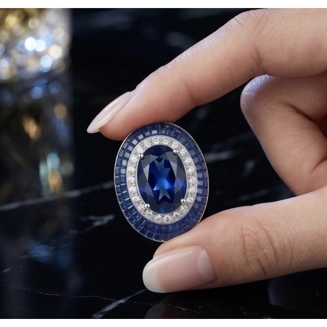 Born to Glam 12.2 carat Sapphire .925 Sterling Silver .925 Sterling Silver Statement Necklace - Close-up of Born to Glam sapphire ring held between fingers.
