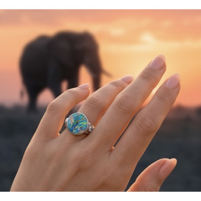 Endless Ocean Genuine 17.5 carat doublet Australian Opal .925 Sterling Silver handmade Ring size 6 3/4 - Opal ring worn on hand with an elephant in the background at sunset.