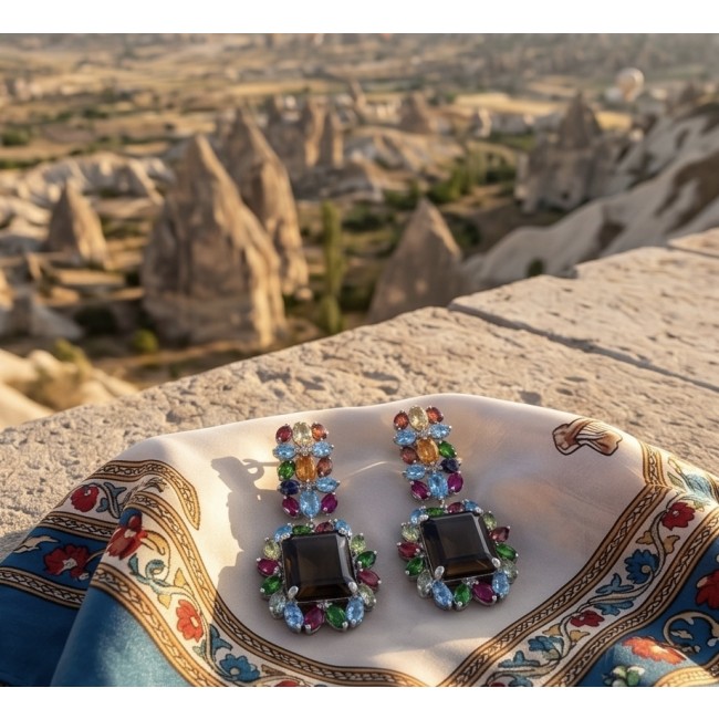 Giovanna 29.5 carat Champagne Smoky Topaz Rhodium over .925 Sterling Silver handmade Statement Earrings - Earrings on scarf with Cappadocia landscape background, top view.