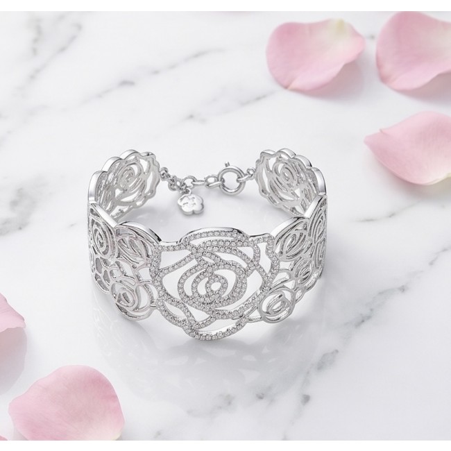 Dolce Vita - Precious Natural 12.5 carat White Topaz rhodium over .925 Sterling Silver handcrafted bracelet - Bracelet on marble with pink petals, intricate rose pattern, top view.