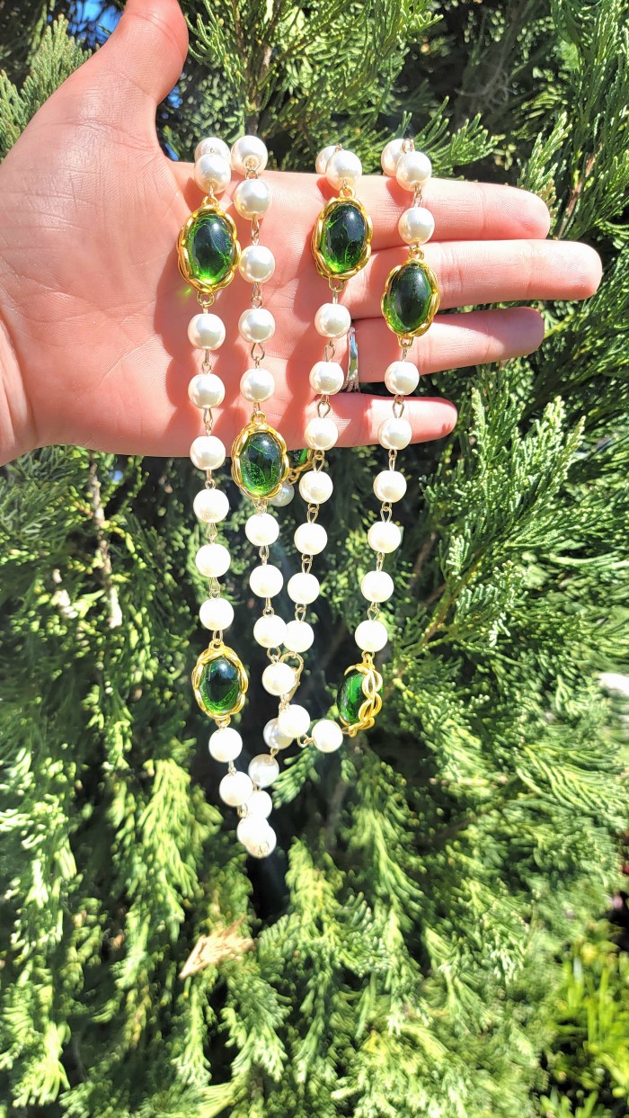 Incredible 48 inches long Freshwater Pearl 10K Gold over .925 Sterling Silver handmade Necklace - Hand holding freshwater pearl necklace with green stones in sunlight.