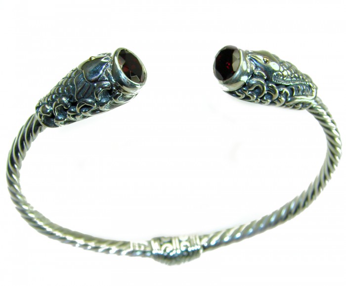 Two Fishes 5.5 carat Mozambique Garnet .925 Sterling Silver handcrafted Statement Bracelet / Cuff - Silver bracelet with fish heads and garnet stones, top view.