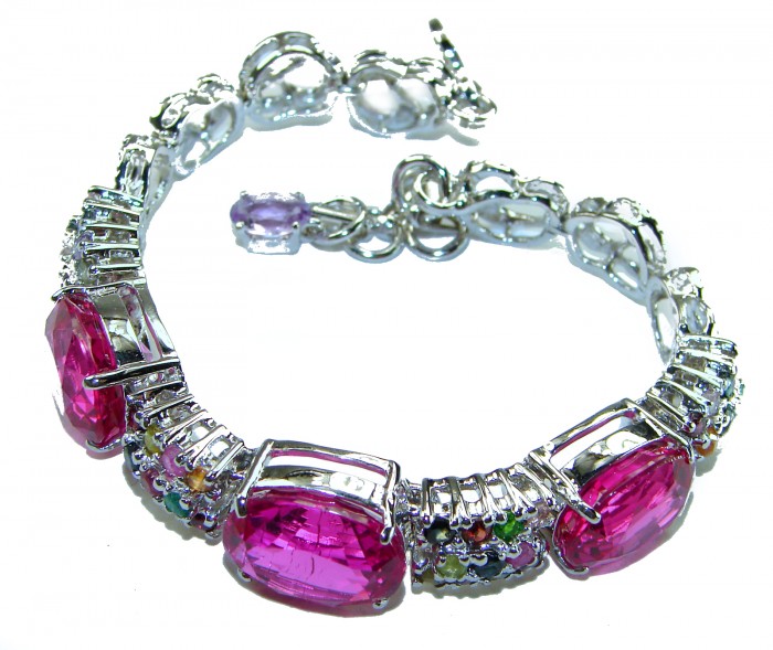 Tiffany - Unapologetically stunning Fuchsia Pink 125.5 carat Pink Sapphire RHODIUM OVER .925 Sterling Silver handcrafted Heavy Bracelet - Bracelet with large pink stones, angled side view.