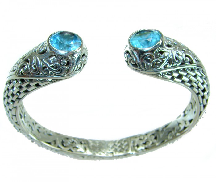Large and Heavy Bali Legacy 45.5 grams authentic 10.9 carat Swiss Blue topaz Floral Bracelet in .925 Sterling Silver handcrafted - Silver bracelet with blue stones, ornate design, top view.