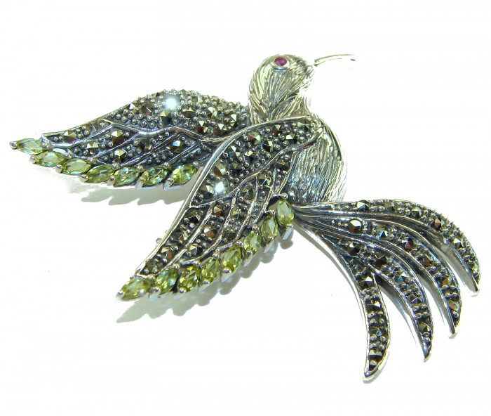 Incredible Flaying Bird Natural 5.9 carat Peridot Marcasite .925 Sterling Silver Brooch - Angled view of bird brooch with peridot and marcasite stones.