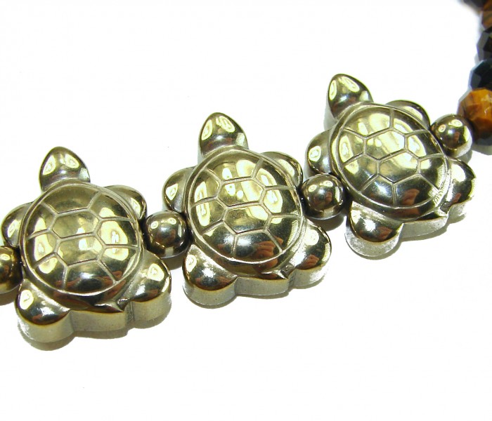 Three Turtles Tigers Eye 14K Gool over .925 Sterling Silver Bracelet - Close-up of turtle-shaped beads on a gold and silver bracelet.