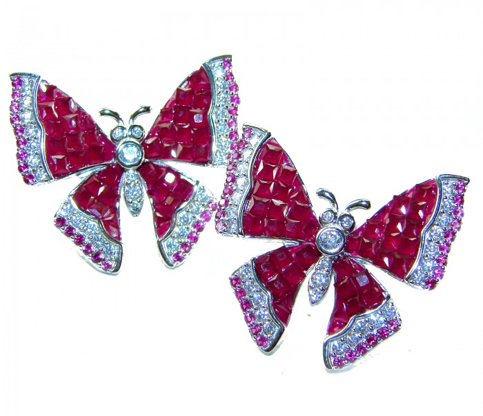 Real Beauty natural 18.2 carat Ruby Butterflies .925 Sterling Silver handcrafted earrings - Close-up of two butterfly brooches with ruby stones on white background.
