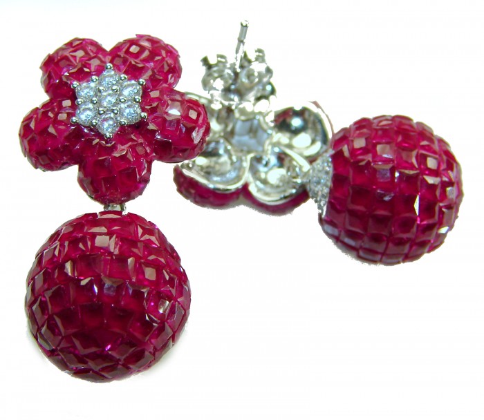 Giovanna - Authentic mystery setting 45.9 carat Ruby .925 Sterling Silver handcrafted earrings - Close-up of ruby earrings with a floral design and diamond accents.