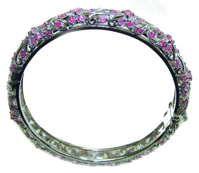 Precious Natural 17.5 carat Ruby .925 Sterling Silver handcrafted Bracelet - Silver bracelet with pink rubies, side view with intricate detailing.