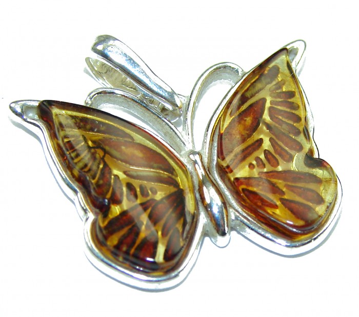 Cute Butterfly Authentic carved Baltic Amber .925 Sterling Silver handcrafted pendant - Butterfly pendant with amber wings in .925 sterling silver, top view.