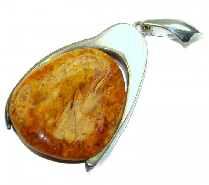 Sea Treasure Prehistoric Authentic Butterscotch Baltic Amber .925 Sterling Silver beautifully handcrafted Pendant - Side view of butterscotch Baltic amber pendant with silver detail.