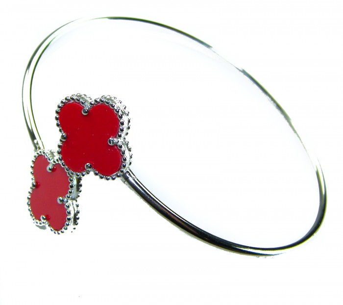 A Red four-leaf clover Coral .925 Sterling Silver handcrafted Bracelet - Red clover coral bangle, sterling silver, close-up view.