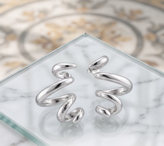 Spiral design Italy made .925 Sterling Silver handcrafted Earrings - Spiral design sterling silver earrings on glass surface, front view.