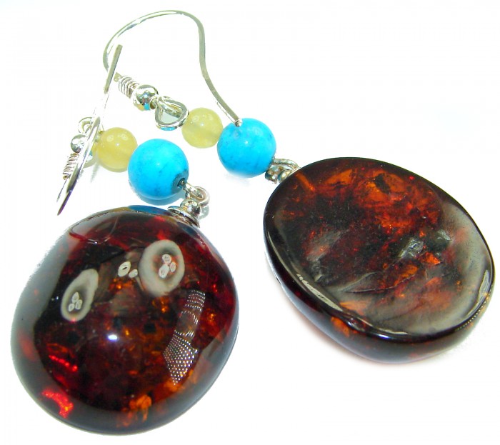 Golden Honey Drops authentic Baltic Amber .925 Sterling Silver earrings - Close-up of Baltic amber and sterling silver earrings with blue beads.
