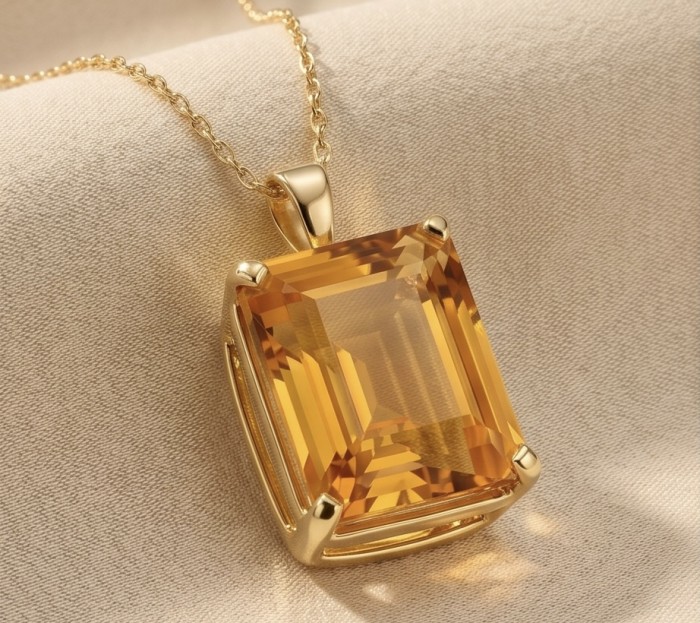Princess cut 25.4 carat Lemon Quartz 18K Gold over .925 Sterling Silver handcrafted pendant - Close-up of Lemon Quartz pendant on gold chain, resting on fabric