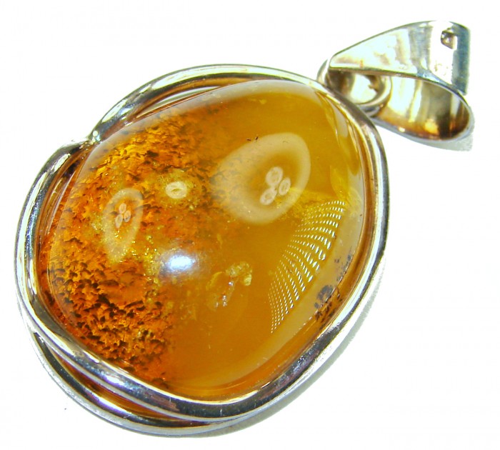 Prehistoric Authentic Baltic Amber .925 Sterling Silver beautifully handcrafted Pendant - Amber pendant with silver setting, close-up of stone and metal detailing.