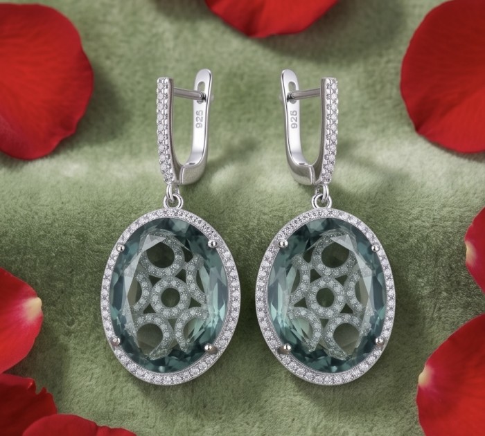 Mystery 22.5 carat Grandidierite .925 Sterling Silver Handcrafted Earrings - Close-up of Grandidierite earrings on green background with red petals
