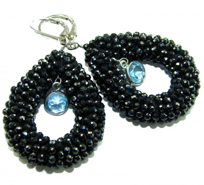 Spiritual Rebirth Precious genuine 29.7 CARAT Black Spinel .925 Sterling Silver STATAMENT earrings - Close-up of teardrop black spinel earrings with blue gem centerpiece.