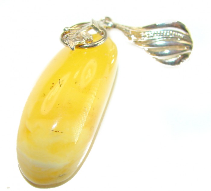 Prehistoric Authentic Buttescotch Baltic Amber .925 Sterling Silver beautifully handcrafted Pendant - Close-up of butterscotch amber pendant with silver leaf detail.