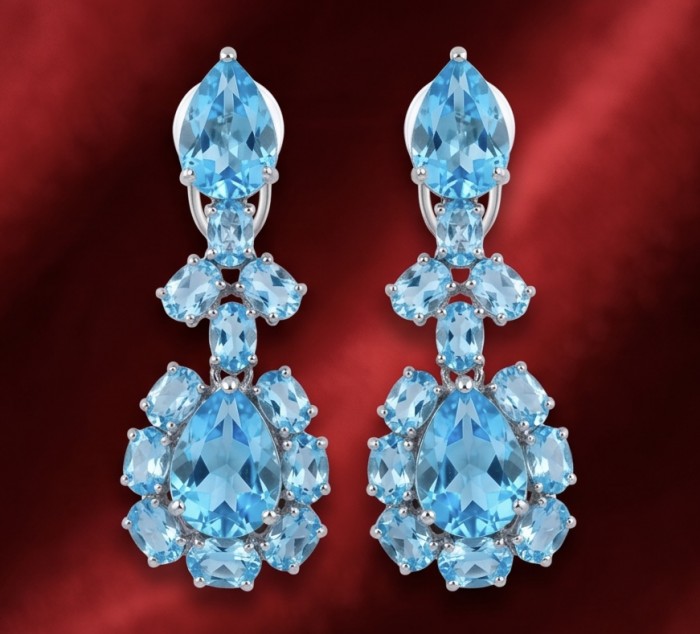 Atlantica 47.7 carat Swiss Blue Topaz .925 Sterling Silver dipped in Rhodium Handcrafted Statement earrings - Front view of Atlantica Swiss Blue Topaz earrings on red background