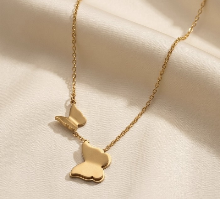 Golden Butterfly 10K Gold over .925 Sterling Silver Italy made necklace - Golden butterfly necklace on draped fabric, angled front view.