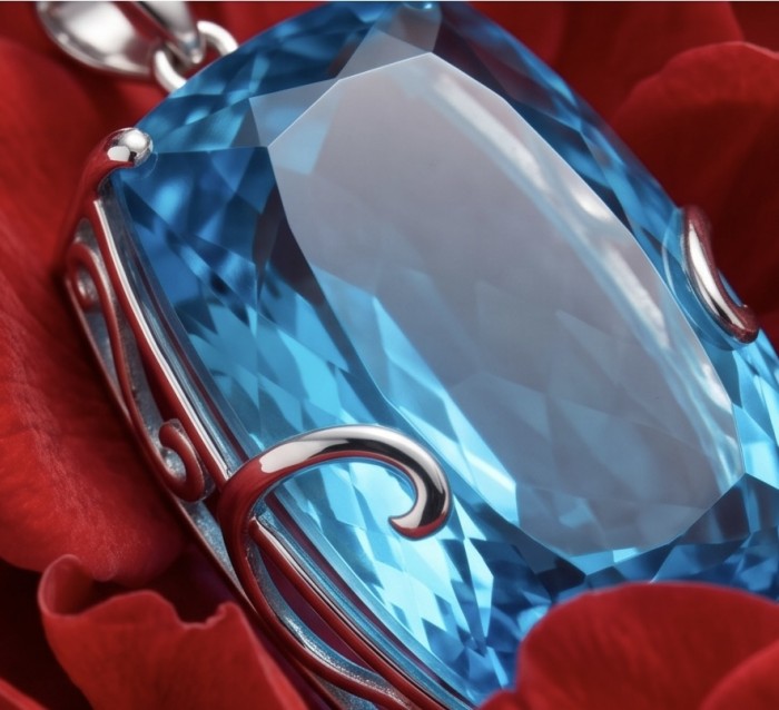Tiffany Incredible baquette cut 32.4 carat Swiss Blue Topaz rhodium over .925 Sterling Silver handcrafted pendant - Close-up of Tiffany Swiss Blue Topaz pendant with red background