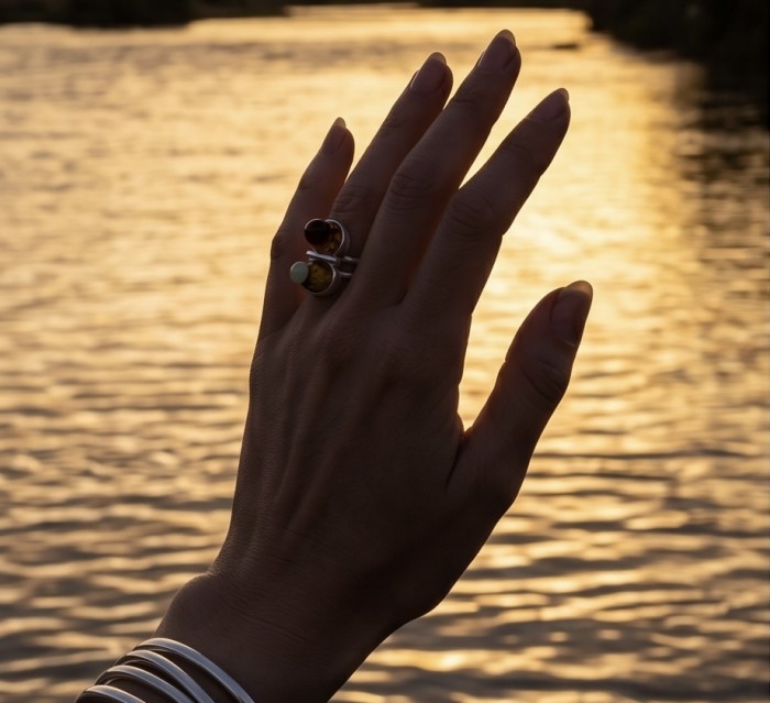 Perfect Harmony - Unique design Authentic Baltic Amber .925 Sterling Silver handcrafted ring; s. 7 adjustable - Amber ring worn on hand, sunset backdrop over water.