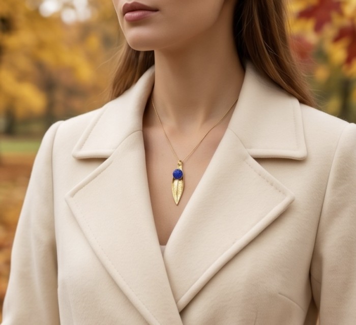 Stylish REAL Leaf dipped in Real gold mystery setting 5.2 carat Sapphire .925 Sterling Silver Pendant - Gold leaf necklace worn on neck with autumn background.