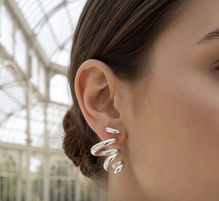Spiral design Italy made .925 Sterling Silver handcrafted Earrings - Side view of spiral .925 Sterling Silver earrings worn on ear.