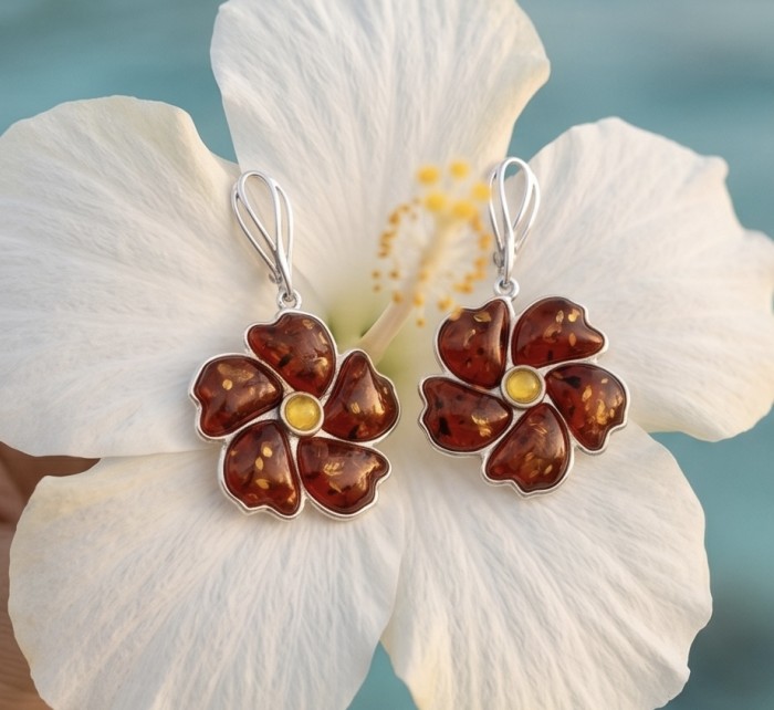 Serenity - Authentic Baltic Amber .925 Sterling Silver handcrafted earrings - Amber flower earrings on white hibiscus background, front view.