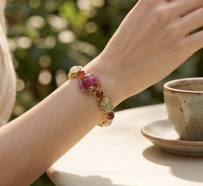 Mademoiselle 41.2 carat Mozambique Ruby Golden Sapphire .925 Sterling Silver dipped in 18K Gold Statement bracelet - Bracelet with rubies and sapphires worn on wrist, close-up view.