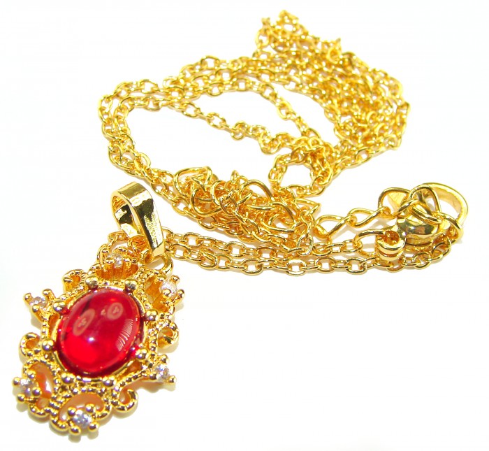ESTANCIA Sublime natural Red topaz 10K Gold over Sterling Silver handmade Necklace - Gold necklace with red topaz pendant, top view on white background.