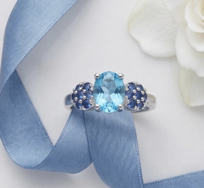 Pacifica 1.5 carat authentic Swiss Blue Topaz .925 Sterling Silver handmade Statement Ring size 7 1/2 - Swiss Blue Topaz ring with ribbon, top view, floral background
