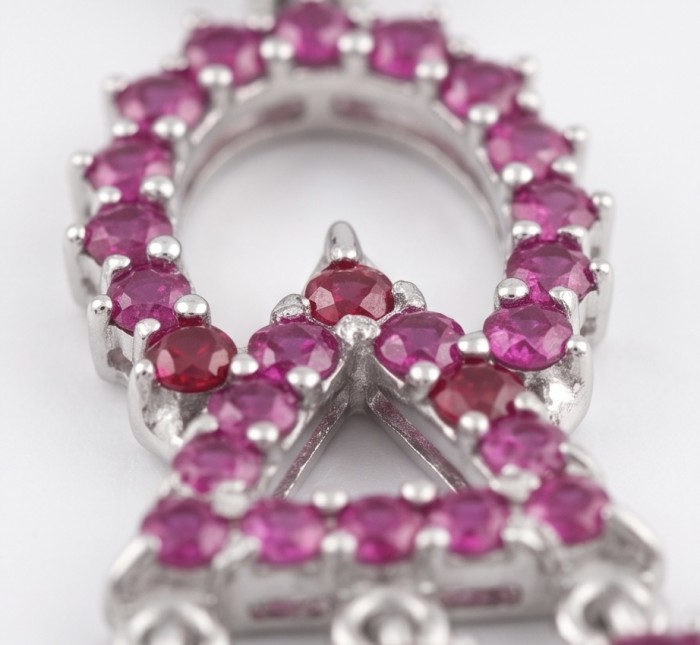 14.2 carat authentic Mozambique Ruby rhodium over .925 Sterling Silver handmade Pendant - Close-up of ruby-studded rhodium pendant showcasing vibrant stones.