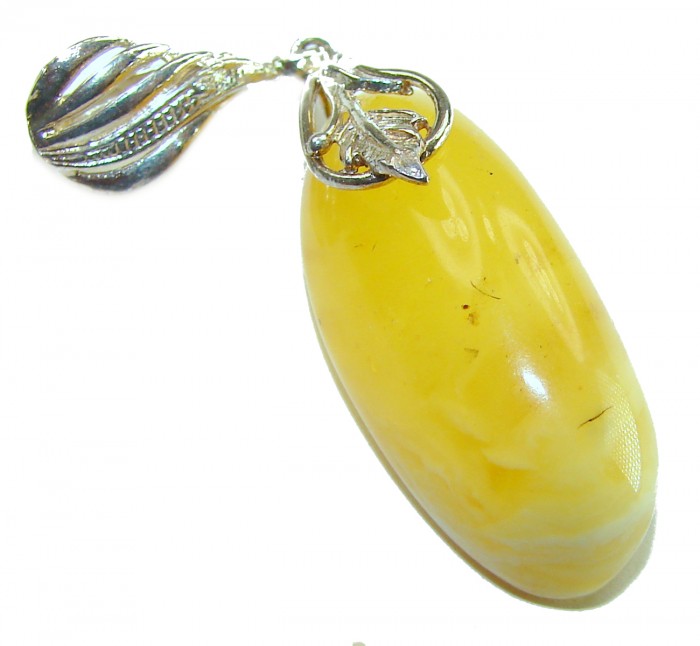 Prehistoric Authentic Buttescotch Baltic Amber .925 Sterling Silver beautifully handcrafted Pendant - Close-up of Butterscotch Baltic amber pendant with silver leaf detail.