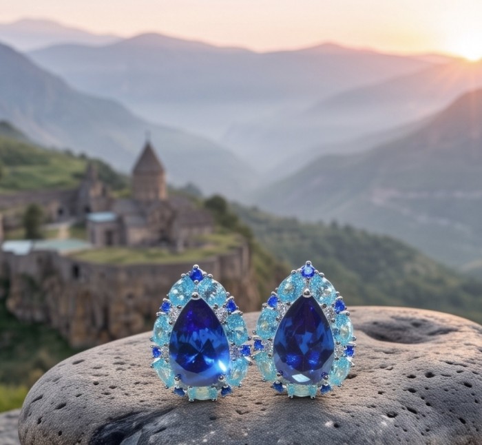 Forget-me-not 7.4 carat London Blue Topaz rhodium over .925 Sterling Silver handmade earrings - Close-up of Forget-me-not blue topaz earrings with mountain backdrop