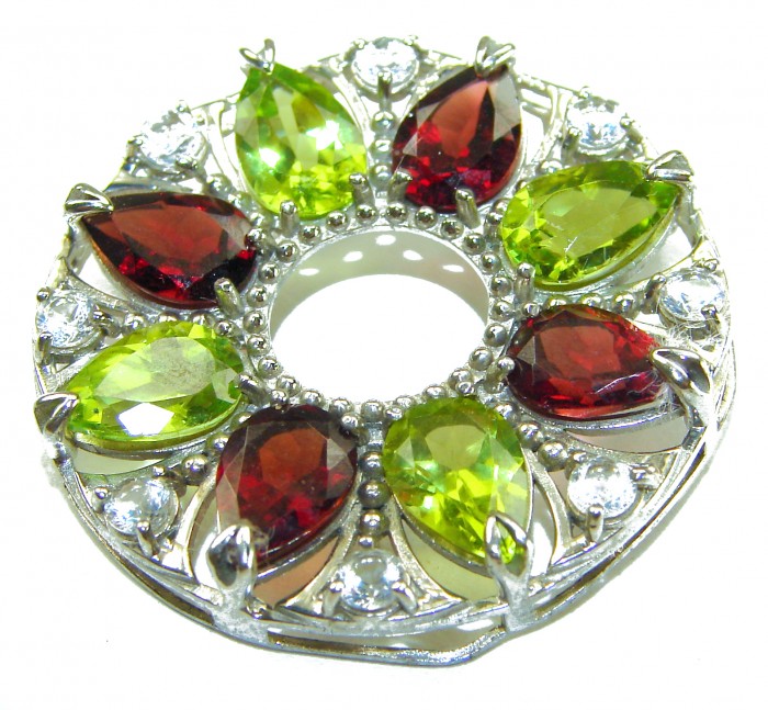 Happiness Authentic 35.5 carat Peridot Garnet .925 Sterling Silver handmade Statement Pendant - Close-up of a gemstone brooch with green and red stones and silver setting.