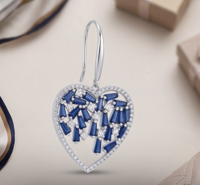 Precious Hearts - authentic 8.5 carat Sapphire .925 Sterling Silver dipped in rhodium handcrafted Statement Earrings - Heart-shaped sapphire earring with silver detail, front view.