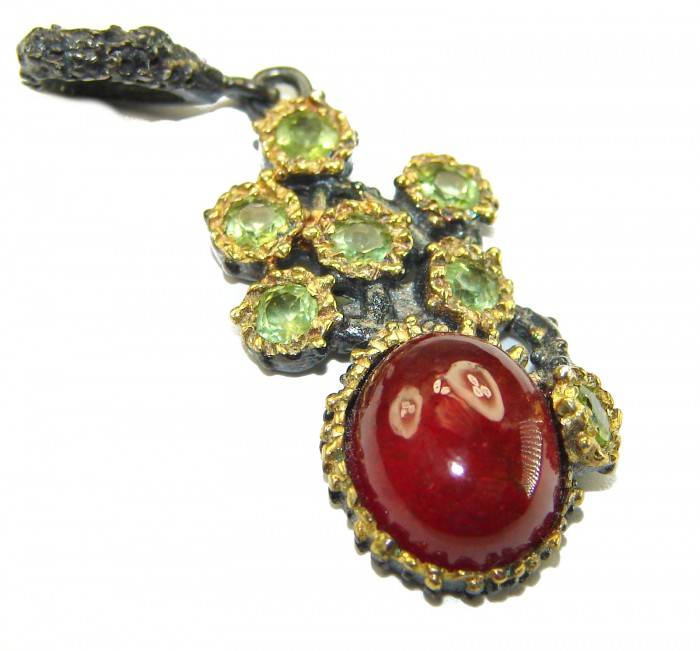 Genuine 4.5 carat Ruby BLACK RHODIUM OVER .925 Sterling Silver handmade Pendant - Close-up of ruby pendant with green gemstones in black rhodium setting.