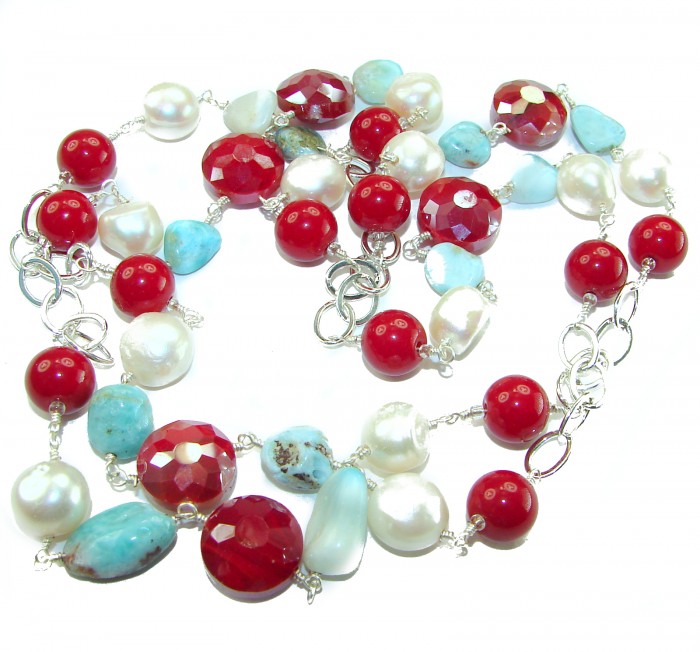 Sublime 32 inches long Red Fossilized Coral handmade Necklace - Colorful beaded necklace with red coral and turquoise, laid flat, angled view
